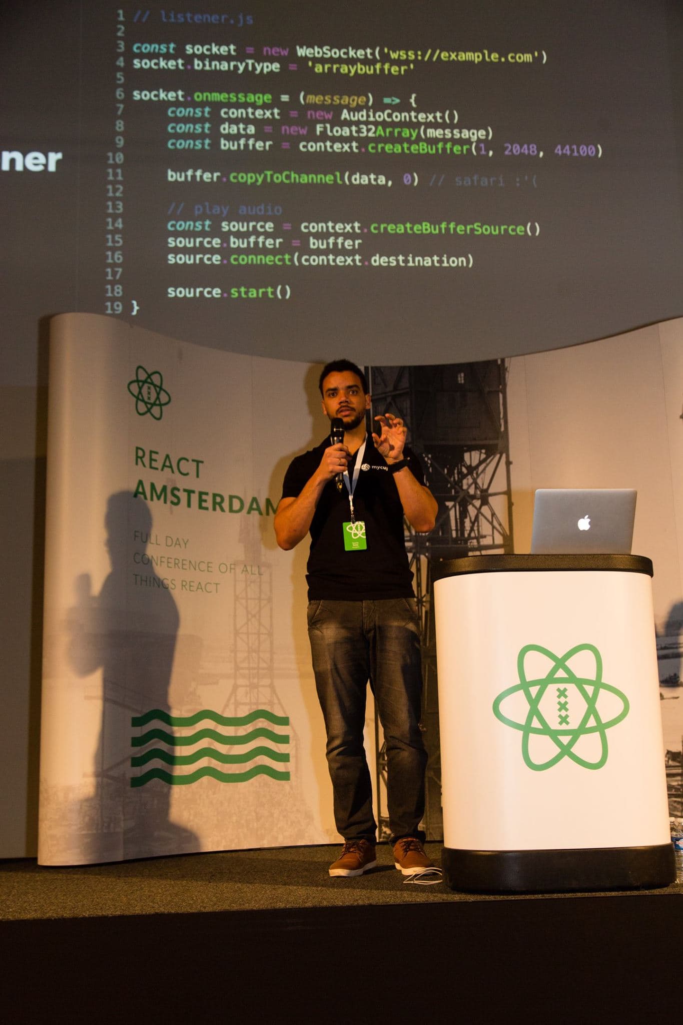 A Memories app screenshot from 7 years on, showing Ricardo on stage at React Amsterdam with Web Audio code projected behind him.